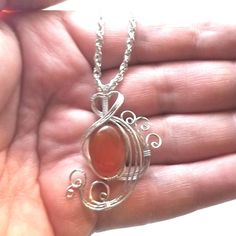 This vibrant red carnelian womans pendant necklace jewelry is wire wrapped in silver and entirely handmade by me and includes free shipping. Please note that the item pictured is a sample only, yours will be the same color, size and shape but there will be some natural variations. This is Hand Wrapped Carnelian Pendant Necklace, Hand Wrapped Carnelian Pendant Jewelry, Bohemian Carnelian Wire Wrapped Jewelry, Spiritual Silver Carnelian Necklace, Handmade Carnelian Jewelry For Gifts, Handmade Carnelian Jewelry As A Gift, Handmade Carnelian Jewelry Gift, Silver Carnelian Necklace With Large Pendant, Silver Carnelian Pendant Necklace