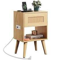 an electronic device is plugged into a wooden nightstand