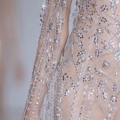 the back of a woman's dress with sequins and beads on it