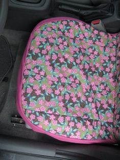 a car seat cover with flowers on it