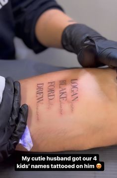 someone getting their arm tattooed with writing on it