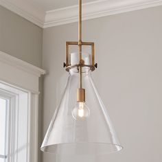 a clear glass light fixture hanging from a ceiling