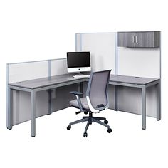 an office cubicle with two desks and a monitor