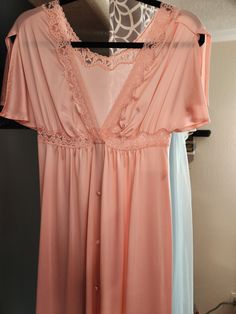 "1970s Vintage Empire Waist Shadowline Dressing Gown/Robe. Size Small, Made in USA, Pink, V Neck, Split short sleeves.  Covered Buttons, Snap at bodice. Bust 32\" Waist 32\" Hips 44\" Length 55\"" Vintage V-neck Sleep Dress, Vintage V-neck Nightgown For Spring, Retro Sleep Dress With Lace Trim, Retro Dresses With Lace Trim For Loungewear, Retro Loungewear Dresses With Lace Trim, Spring Vintage V-neck Nightgown, Vintage Pink V-neck Nightgown, Dressing Gown Robe, Soft Bra