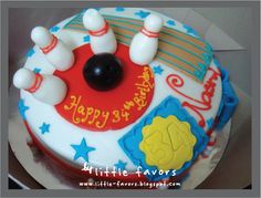 a birthday cake decorated with bowling pins and balls