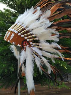 Short Brown Indian Headdress Replica made with rooster dyed feathers and shell white work in the front This great adult headdress is entirely handmade and truly adorable. Perfect photography prop for your special ocasion. Ties in the back for a perfect fit. This will be precious for your costume, or even room decor. Head circumference: 59 centimeters / 23 inches ✈️ Worldwide shipping 🐤 I only use authentic feathers ⛺️ I guarantee highest quality, 100% hand-crafted White Bohemian Ceremonial Headpiece, White Bohemian Costume Hats And Headpieces For Festivals, White Headpieces For Carnival Festival, White Bohemian Costume Hat For Festivals, Bohemian White Headpiece For Festival, Ceremonial White Handmade Headpieces, Ceremonial Handmade White Headpiece, Handmade White Headpieces For Ceremonial Events, Perfect Photography