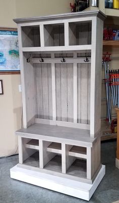 a white wooden bench sitting inside of a room