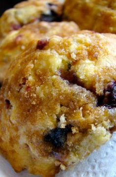 three blueberry muffins sitting on top of a paper towel