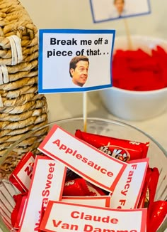 a bowl filled with apples and candy next to a sign that says break me off a piece of that