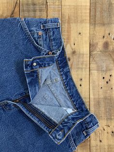 "High waisted 90's denim shorts. Made by Levi's in light dark denim wash. Shorts are in excellent clean condition. Perfectly worn in with light naturally distressed character. These have been cut off and washed once. Measurements are taken zipped or buttoned up and laid comfortably flat then x 2 for total circumference (inches) Levis 550 Tag Size 34 100% Cotton Waist 33\" Hips 45\" Length 14\" Inseam 2.5\" Rise 12.5\" leg opening circumference 25.5\" All items are free of rips, tears, holes, and Recycled Denim Cutoff Jean Shorts With Pockets, Cutoff Jean Shorts With Pockets In Recycled Denim, Dark Wash Rigid Denim Jean Shorts With Pockets, Dark Wash Jean Shorts With Pockets In Rigid Denim, Denim Blue Straight Leg Rigid Denim Shorts, Denim Blue Straight Leg Shorts In Rigid Denim, Blue Rigid Denim Shorts, 90s High Waist Dark Wash Bottoms, Dark Wash Recycled Denim Jean Shorts With Pockets