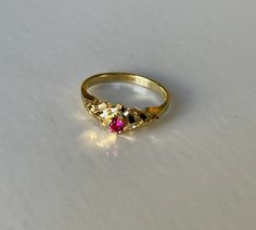 Brutalist 14K Yellow Gold Ring with Ruby Stones, 1.6 grams, Size 6.25 Weight: 1.6 grams Size: 6.25 Number of Stones: 1 Stone: Ruby Tested: Yes.               Gemstone: Presidium Duo Gemtester Markings: 14K, but tested 11K Condition: Very good preowned. Refer to pictures for condition. All jewelry is professionally cleaned before shipping. Gold Dainty Ruby Ring For Formal Occasions, Dainty Gold Ruby Ring For Formal Occasions, Yellow Gold Hallmarked Ruby Promise Ring, 14k Gold Hallmarked Ruby Ring For Promise, 14k Gold Ruby Ring With Diamond Cut For Gift, Yellow Gold Sapphire Ring With Diamond Cut For Gift, 14k Gold Diamond Cut Ruby Ring For Promise, Yellow Gold Birthstone Ring With Diamond Cut For Promise, Heirloom Ruby Ring With Diamond Cut In 14k Gold