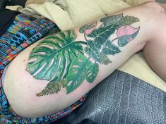 a person laying on top of a bed with a tattoo on their arm and leg