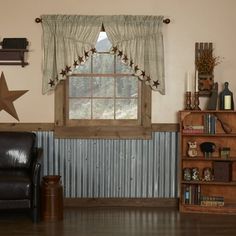 a living room filled with furniture and a star hanging on the wall next to a window