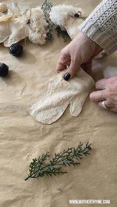 someone is making some paper flowers out of leaves and other things that are on the table