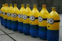 several yellow and blue bottles with minion faces painted on them, lined up in a row