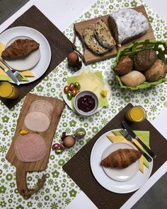 a table topped with plates and bowls filled with food