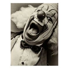 a creepy clown with his mouth open and tongue out