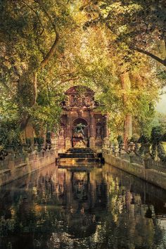 a painting of a fountain in the middle of a park with lots of trees around it