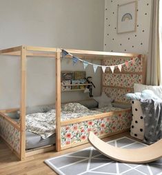 a child's bedroom with two beds and a rocking chair