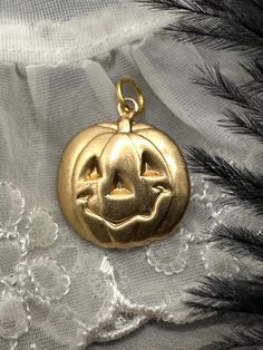 GREAT FOR YOUR CHARM NECKLACE! A HAPPY JACK O LANTERN! These charms are new and unworn, made from decades old stamping machines. Lightweight and can be worn a variety of ways including as a pendant, earrings, on a bracelet, anklet or on a charm necklace. Single sided, hollow back. These charms are made of raw brass which will patina over time and may already have some patina. There may be color variations in the brass due to this.  Please refer to pic with ruler for measurements in inches.  Jump Halloween Themed Jewelry For Costume Party, Themed Jewelry For Halloween Costume Party, Novelty Jewelry For Halloween Costume, Novelty Halloween Costume Jewelry, Halloween Novelty Jewelry With Charms, Fun Nickel-free Jewelry For Halloween, Collectible Gold Jewelry For Halloween, Halloween Handmade Novelty Jewelry, Handmade Costume Jewelry For Halloween