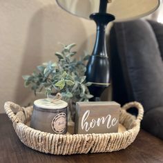 a table with a candle, potted plant and some wood block signs on it