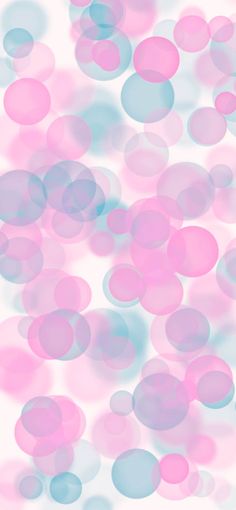 pink and blue circles are floating in the air on a white background with soft light