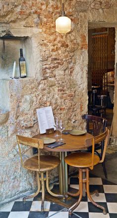 a table and chairs in a room with a checkered floor