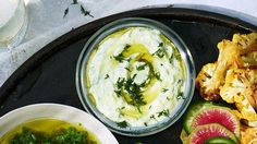 an assortment of fruits and dips on a tray