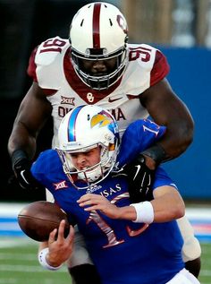 a football player is being tackled by another player