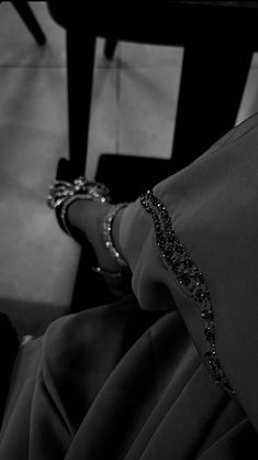 black and white photograph of woman's feet in high heeled shoes with beading