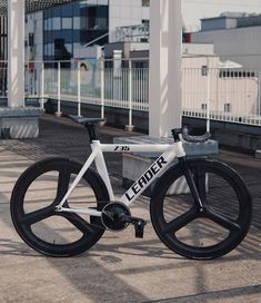 a white and black bike parked in front of a building