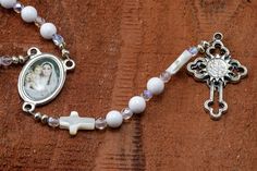 a rosary with an image of a woman on it