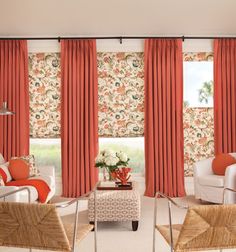 a living room with red curtains and white furniture