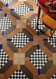 a table and chair in a room with checkered floor tiles on the floor,