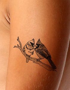 two birds sitting on a tree branch tattoo