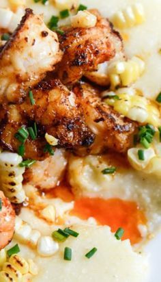 some shrimp and corn on top of mashed potatoes