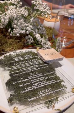 there is a menu on the table with flowers