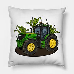 a green and yellow tractor with corn stalks on it's back sitting on a white pillow