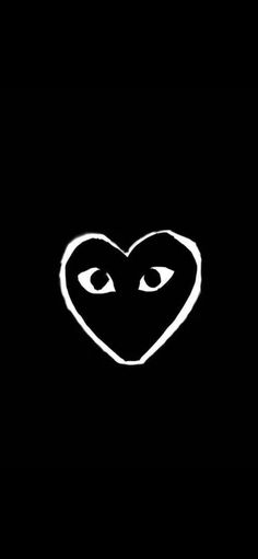 a heart with an eye drawn on it in the middle of a black background,