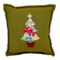 a green pillow with a red potted christmas tree on the front and bottom side