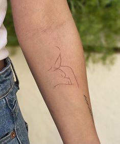 a woman's arm with a tattoo on the left side of her right arm