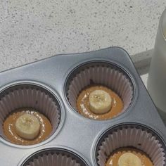 four cupcakes in a muffin tin with peanut butter