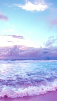 an ocean view with waves coming in to the shore and blue sky above it at sunset