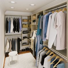 a walk in closet filled with lots of clothes and shoes on hangers next to a white rug