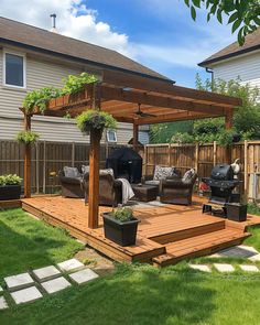 a backyard with a wooden deck, patio furniture and an outdoor grill on the grass