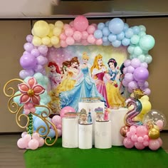 a table with balloons and decorations for a princess themed birthday or baby's first birthday