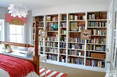 a bedroom with bookshelves and a bed in it