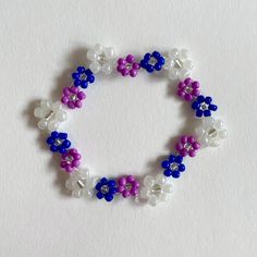 Handmade bracelet. Made with elastic nylon thread. Handmade Purple Flower Beaded Bracelets, Adjustable Purple Flower Beaded Bracelets, Adjustable Purple Beaded Wristband, Purple Flower Bracelets For Friendship, Adjustable Purple Wristband With Round Beads, Casual Handmade Purple Stretch Bracelet, Beading Tutorials, Handmade Bracelet, Handmade Bracelets