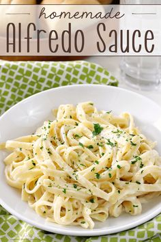 homemade alfredo sauce on a white plate with bread in the background and text overlay