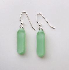 Mint Green Extra Long Fused Glass Dangle  Earrings Perfect for adding that POP of colour to any outfit. a gorgeous soft mint green base with a clear top to add some extra shine.  Each pair of earrings is created in my home studio and kiln fired. Earrings may vary slightly in size and contain small air bubbles which are characteristics of kiln fused glass. No two pairs are ever the same, making them a one of a kind pair of wearable art! Please note you are not purchasing the exact pair of earring Modern Green Glass Earrings, Green Dangle Earrings With Recycled Glass, Green Dangle Earrings In Recycled Glass, Green Recycled Glass Dangle Earrings, Soft Mint Green, Soft Mint, Clear Top, Long Dangle Earrings, Air Bubbles